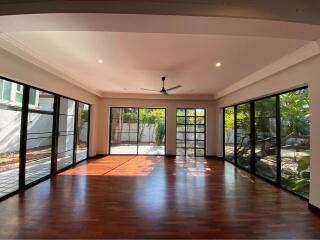 Spacious living room with large windows and garden view