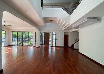 Spacious living area with hardwood floors and large windows