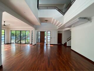 Spacious living area with hardwood floors and large windows