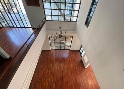 Spacious living room with wooden floors and large windows