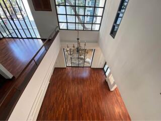 Spacious living room with wooden floors and large windows