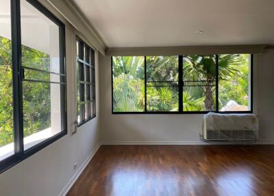 Living room with large windows and wooden flooring