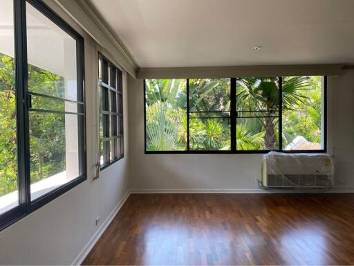 Living room with large windows and wooden flooring