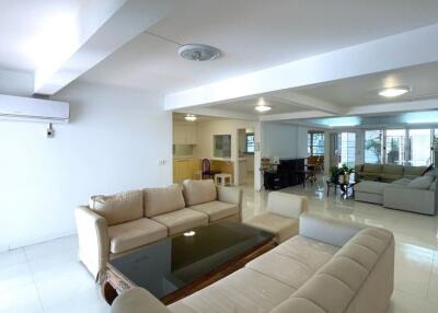 Spacious living room with modern furnishings and large glass table