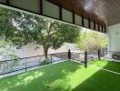 Spacious balcony with artificial turf and modern railing