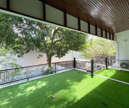 Spacious balcony with artificial turf and modern railing