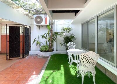 Modern patio with seating area and air conditioning unit