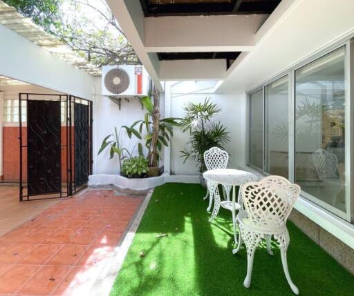 Modern patio with seating area and air conditioning unit