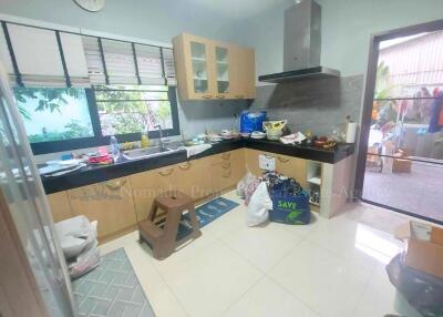 Modern kitchen with wooden cabinets and large windows