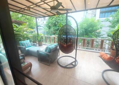 Spacious balcony with seating and hanging chairs