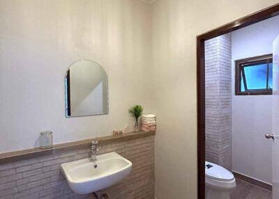 Modern bathroom with sink, mirror, and toilet