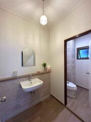 Modern bathroom with sink, mirror, and toilet