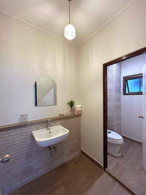 Modern bathroom with sink, mirror, and toilet