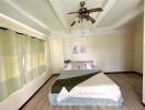 Spacious bedroom with ceiling fan and double bed