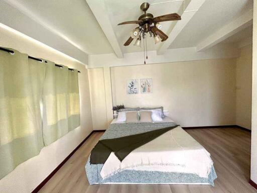 Spacious bedroom with ceiling fan and double bed