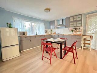 Spacious kitchen with modern appliances and dining area