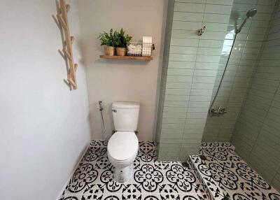 Modern bathroom with tiled shower and ornamental floor tiles