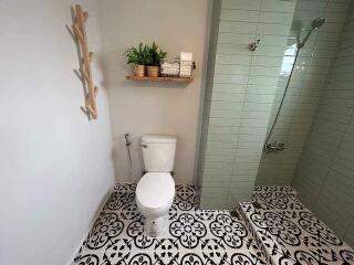 Modern bathroom with tiled shower and ornamental floor tiles