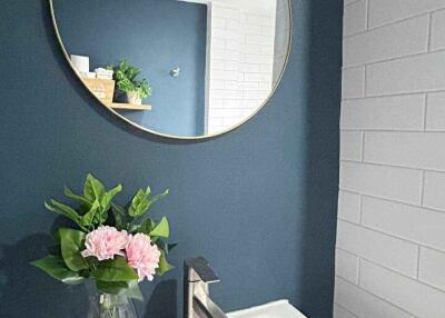 Modern bathroom with round mirror and sink