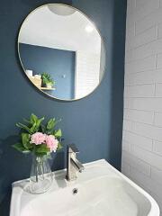 Modern bathroom with round mirror and sink