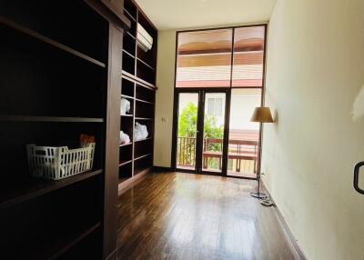 Bedroom with wooden floors and large shelves