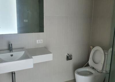 Modern bathroom with sink, mirror, and toilet