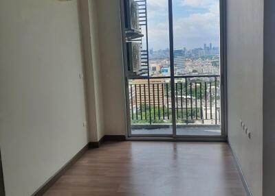 Empty living area with a view of the city from the balcony