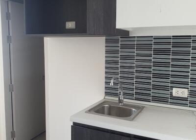 Modern kitchen with tiled backsplash and dark cabinets