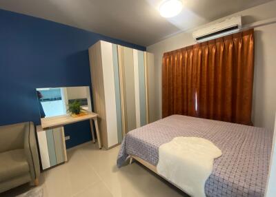 Well-furnished bedroom with a bed, wardrobe, mirror, and air conditioner