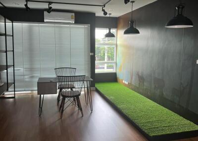 Modern office with desk, chair, and large window with blinds.