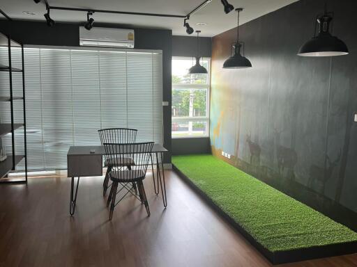 Modern office with desk, chair, and large window with blinds.