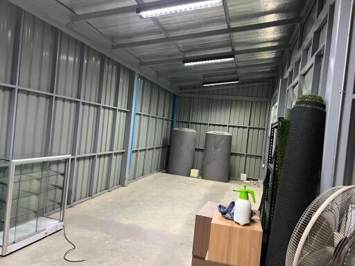 Clean and organized storage area with metal walls and ceiling