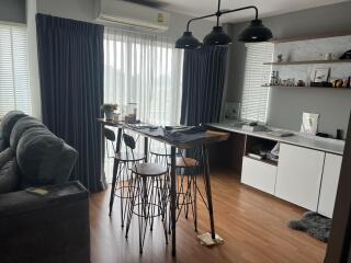 Modern dining area with high table and stools