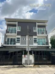 Exterior view of a multi-story residential building with balconies