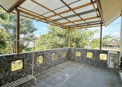 Covered balcony with tiled flooring and open view