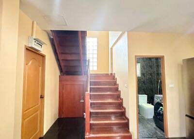 View of a staircase in a home with access to a bathroom and additional room