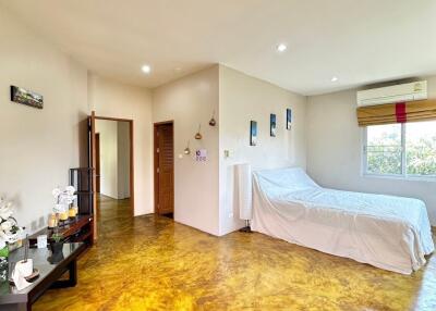 Spacious bedroom with bed and window