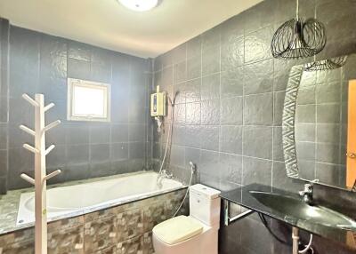 Modern bathroom with tiled walls and bathtub