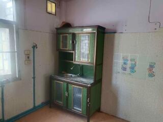 Small kitchen area with vintage cabinet and sink