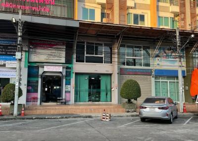 Exterior view of a mixed-used building with multiple businesses and parking spaces