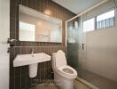 Modern bathroom with glass shower and tiled walls