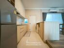 Modern kitchen with wooden cabinetry, stainless steel appliances, and adjacent dining area