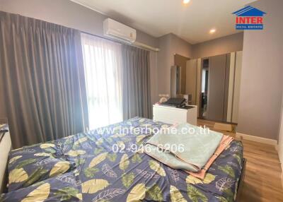 Bedroom with bed, curtains, air conditioner, and wardrobe