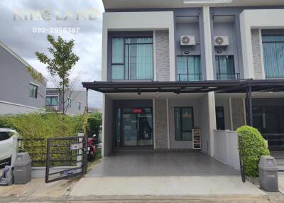 Front view of a modern two-story townhouse with driveway