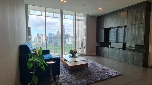 Modern living room with a large window and city view