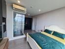 Modern bedroom with a bed, air conditioning, and a glass door leading to a balcony