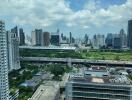 High-rise buildings in a city with green spaces and a highway