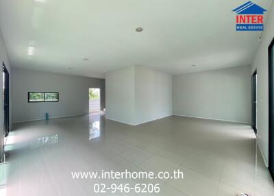 Spacious living area with tiled flooring and large windows