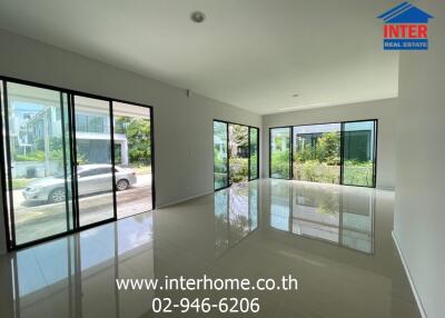 Spacious living area with large windows and natural light