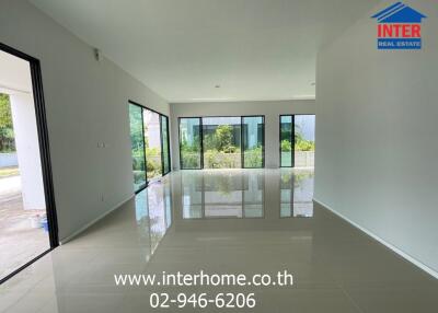 Spacious living room with large windows and natural light